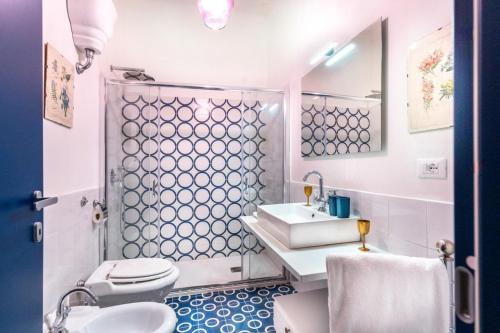 a bathroom with a sink and a toilet at Dimora Filangieri in Massa Lubrense
