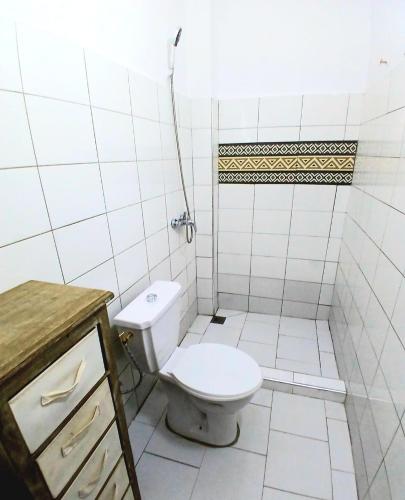 a white bathroom with a toilet and a shower at Cozy Studio with Private Jacuzzi and Pool! in Saly Portudal