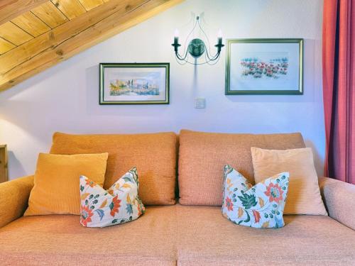 a couch with pillows on it in a living room at Sonnenhof Seeg 14 in Seeg