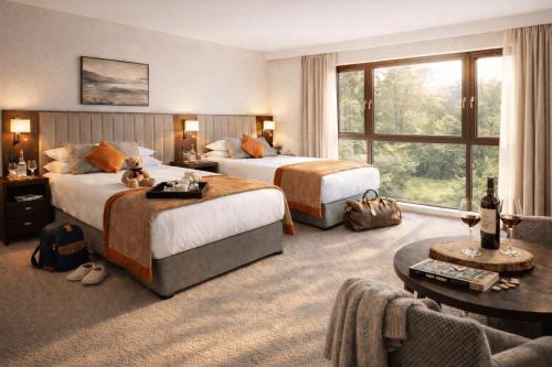 a hotel room with two beds and a large window at Westport Woods Hotel & Spa in Westport