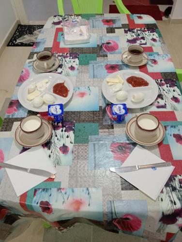 a table with plates of food on top of it at Agréable in Hennchir Ksar Rhaleb