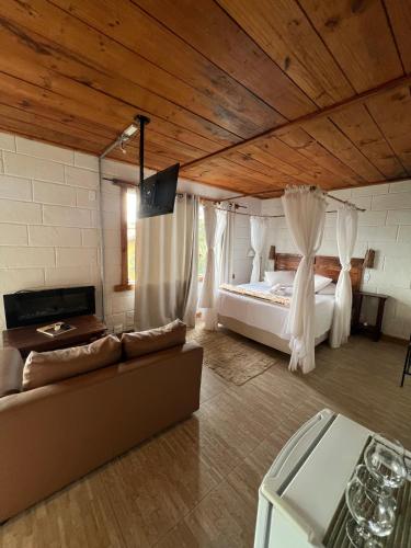 a bedroom with a bed and a couch in a room at Pousada do Rei Arthur in Lavras Novas