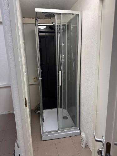 a shower in a bathroom with a glass door at Affordable, fully equipped practical housing! in Laivaniemi