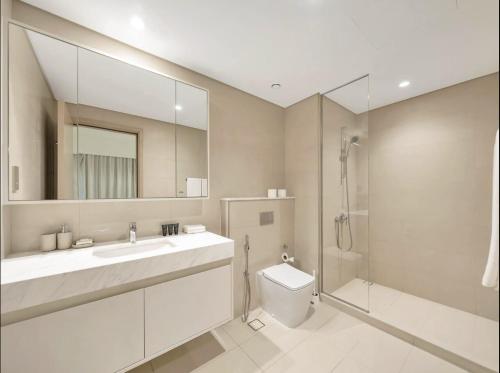 a bathroom with a sink and a toilet and a shower at Luxurious Private Room in Burj Vista with Burj Khalifa View in Dubai