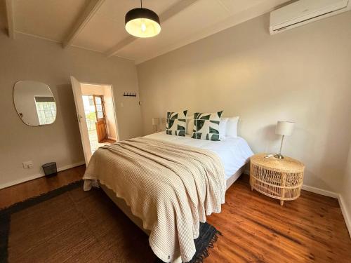 a bedroom with a large bed and a window at Die Stal in Wellington