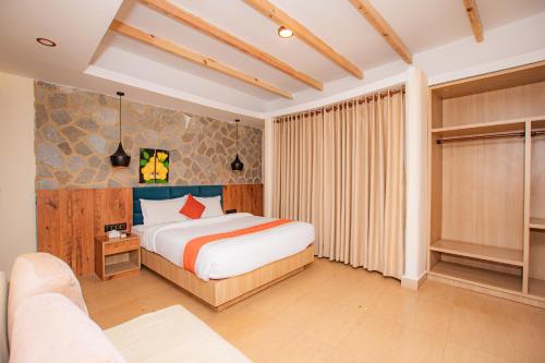 a bedroom with a bed and a couch at Bodhi Suite Boutique Hotel & Wellness in Pokhara