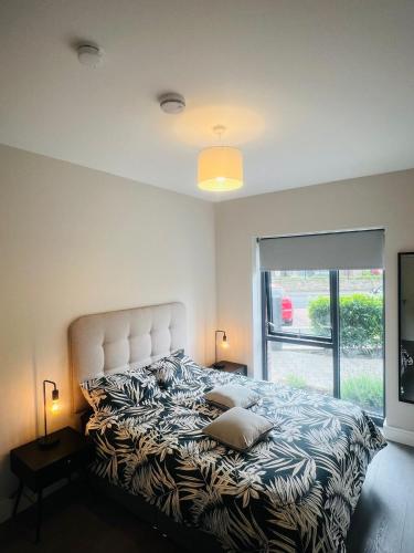 a bedroom with a large bed with a large window at Single Apartment with kitchen in London