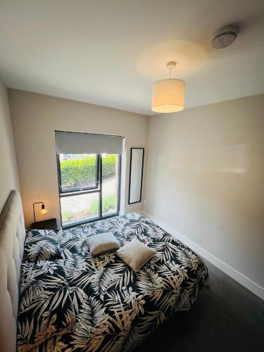 a bedroom with a bed with a large window at Single Apartment with kitchen in London