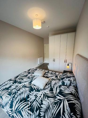 a bedroom with a black and white bed with pillows at Single Apartment with kitchen in London