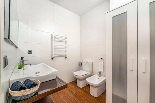 a white bathroom with a sink and a toilet at Art City Villa in Porto