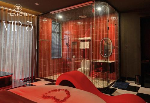 a red tiled bathroom with a shower and a toilet at TROY HOTEL - Bà Rịa in Ấp Long Kiên I