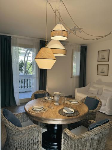 a living room with a wooden table and chairs at Grecale - Villa Marina in Marina di Andora