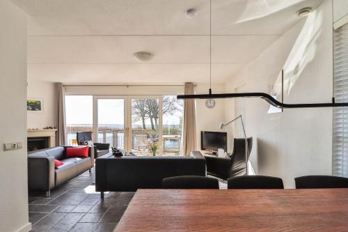 a living room with a couch and a table at Villa Seaview met Sauna in Makkum