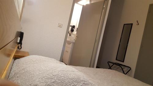 Säng eller sängar i ett rum på Hotel Glaizette