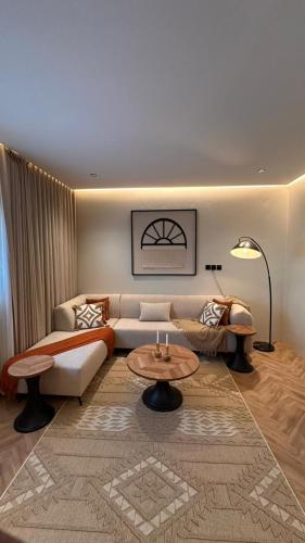a living room with a couch and a table at Grandstay in Al Hofuf