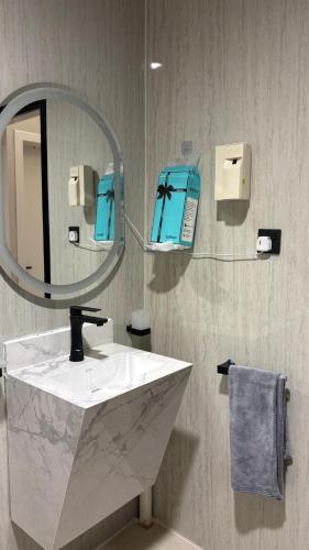 a bathroom with a sink and a mirror at Grandstay in Al Hofuf