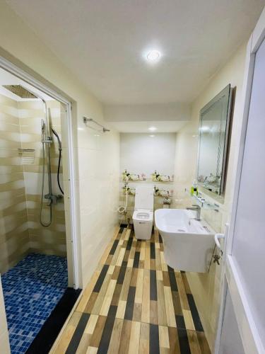 a bathroom with a toilet and a sink and a shower at Palmyra resort in Jaffna