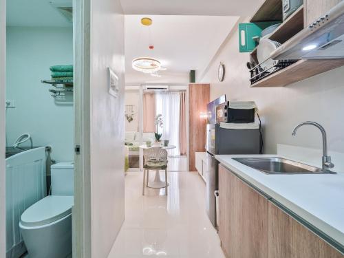 a small kitchen with a sink and a toilet at Kajas Condo Luxe at Primeworld District near Mactan-Cebu International Airport in Lapu Lapu City