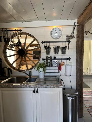 a kitchen with a wooden wheel hanging on the wall at Cosy Cottage Vollheim in Lillehammer
