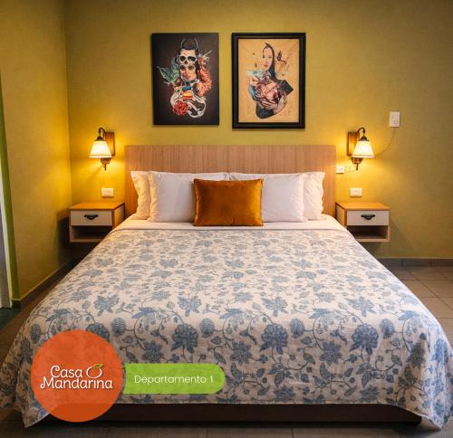 a bedroom with a large bed with two lamps at Casa Mandarina San Luis in La Punta