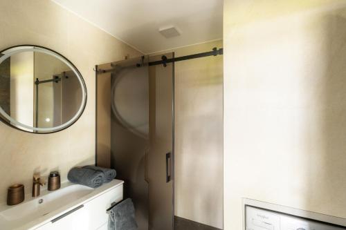 a bathroom with a shower and a mirror at Laumiņas in Pavasari