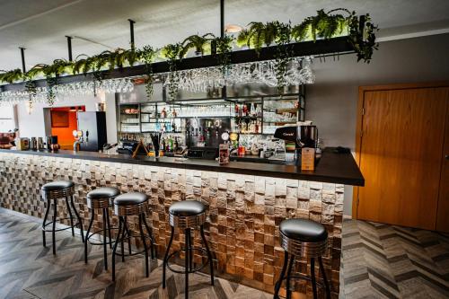 a bar with a row of stools in a restaurant at Hótel Valaskjálf in Egilsstaðir