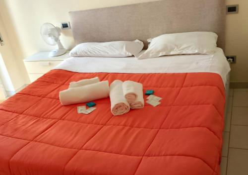 a bed with two towels and two pillows on it at BnB Cairoli - Homezon in Diano Marina