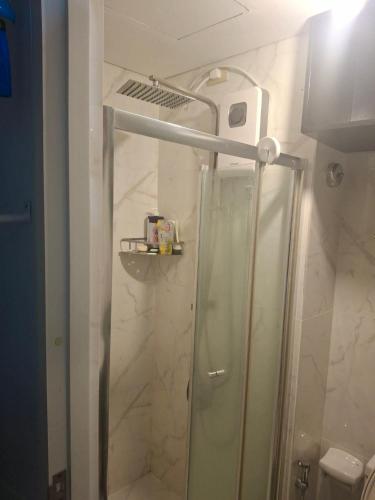 a shower with a glass door in a bathroom at Alabang Staycation by East Bay Residence in Sampong