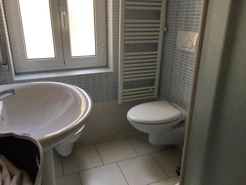 a bathroom with a toilet and a sink and a tub at BnB Cairoli - Homezon in Diano Marina