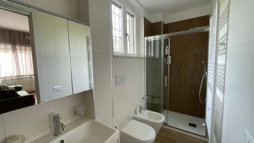 a bathroom with a sink and a toilet and a mirror at La Contessa Home in Avellino