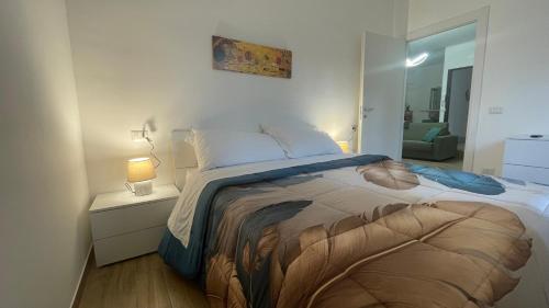 a bedroom with a large bed with a lamp and a mirror at La Contessa Home in Avellino