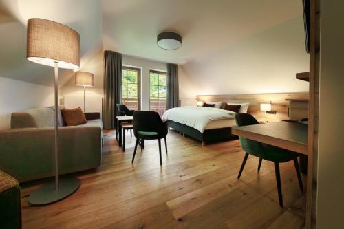a hotel room with a bed and a desk at Hotel Amselgrundschlößchen in Kurort Rathen