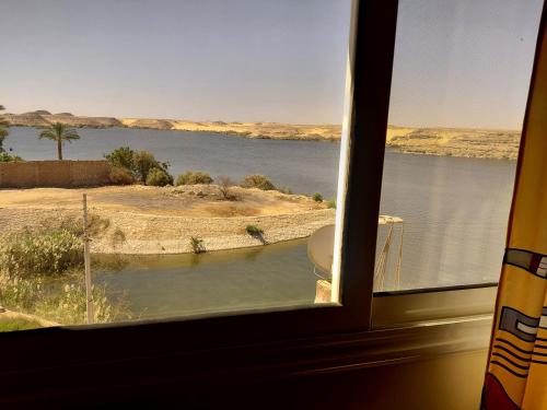 a view of a body of water from a window at Amon guest house in Abu Simbel