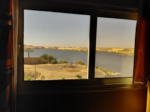 a window with a view of a body of water at Amon guest house in Abu Simbel