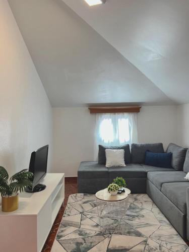 a living room with a couch and a table at Maria apartment in Ponta do Sol