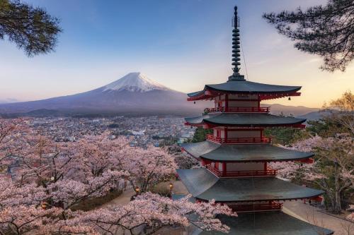 a pagoda with a mountain in the background at 不二咲 in Fujiyoshida