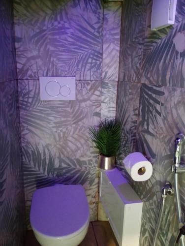 a purple bathroom with a toilet and a plant at B&B Romeo in Bari