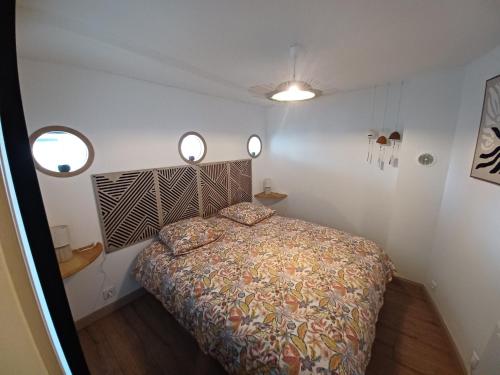 a bedroom with a bed and three lights on the wall at Le bon accueil in Coucy
