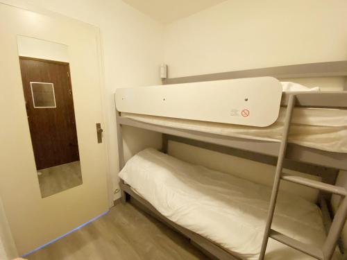 a small room with bunk beds and a mirror at BLEUE OCEANE - Studio, Piscine commune - U65 in Carnac