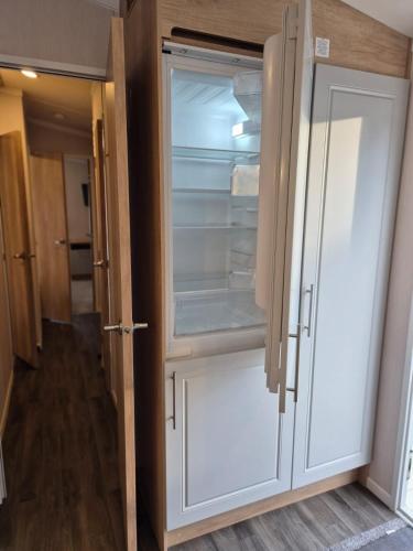 a white refrigerator with its door open in a hallway at Birchington Vale - Sleeps 8, Family friendly in Birchington