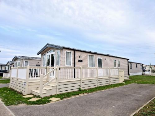 a mobile home with a white fence at Birchington Vale - Sleeps 8, Family friendly in Birchington