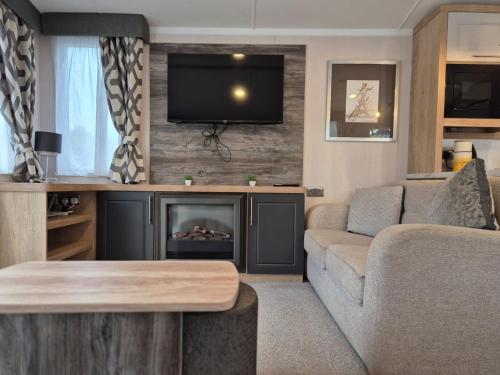 a living room with a couch and a fireplace at Birchington Vale - Sleeps 8, Family friendly in Birchington