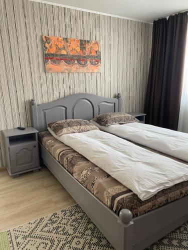 a bedroom with a large bed with at Casa Crăciun in Mănăstirea Humorului
