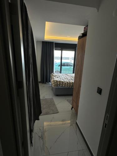 a hallway with a door to a room with a bed at Mertcan Doruk in Side