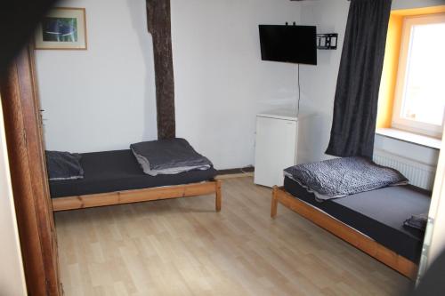a room with two bunk beds and a television at Toscana1 in Freimersheim