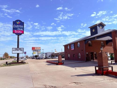 a building with a sign for a gas station at Express Inn & Suites Houston Katy in Katy