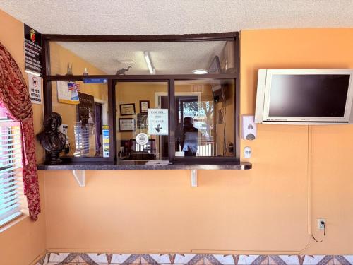 a window in a room with a tv on the wall at Express Inn & Suites Houston Katy in Katy