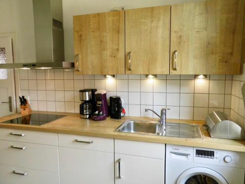 a kitchen with a sink and a dishwasher at Ihr Domizil auf Zeit in Würzburg in Würzburg