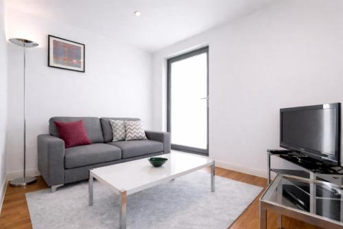 a living room with a couch and a tv at Roomspace Serviced Apartments - Chorus in London