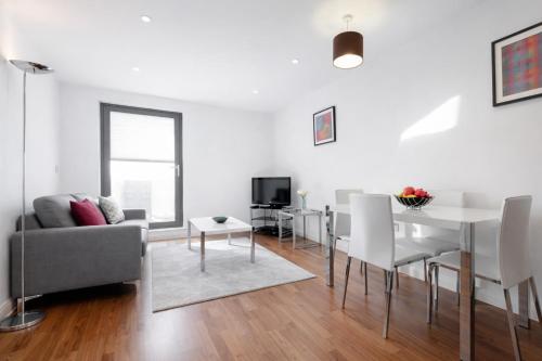 a living room with a couch and a table at Roomspace Serviced Apartments - Chorus in London